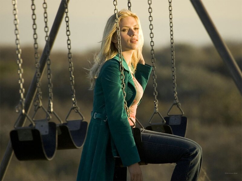 Woman on a swing at sunset
