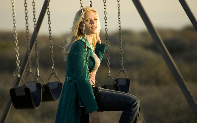 woman on a swing at sunset