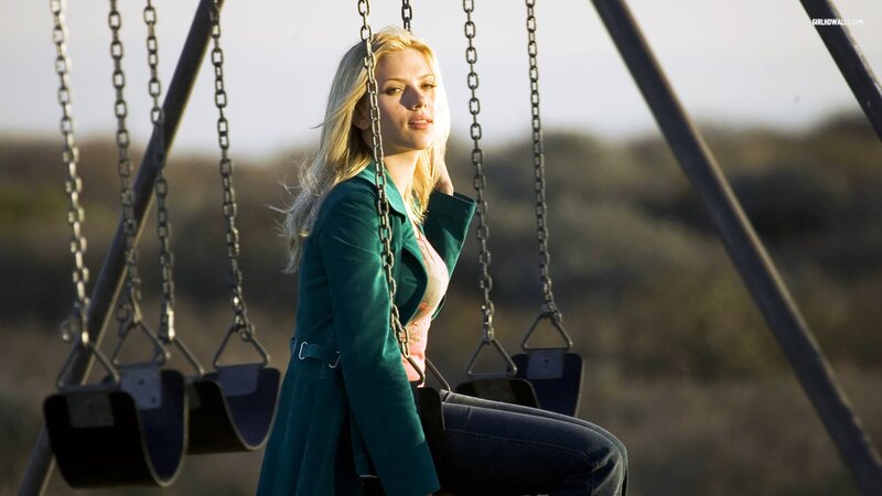 woman on a swing at sunset