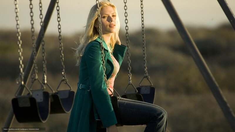 Woman on a swing at sunset