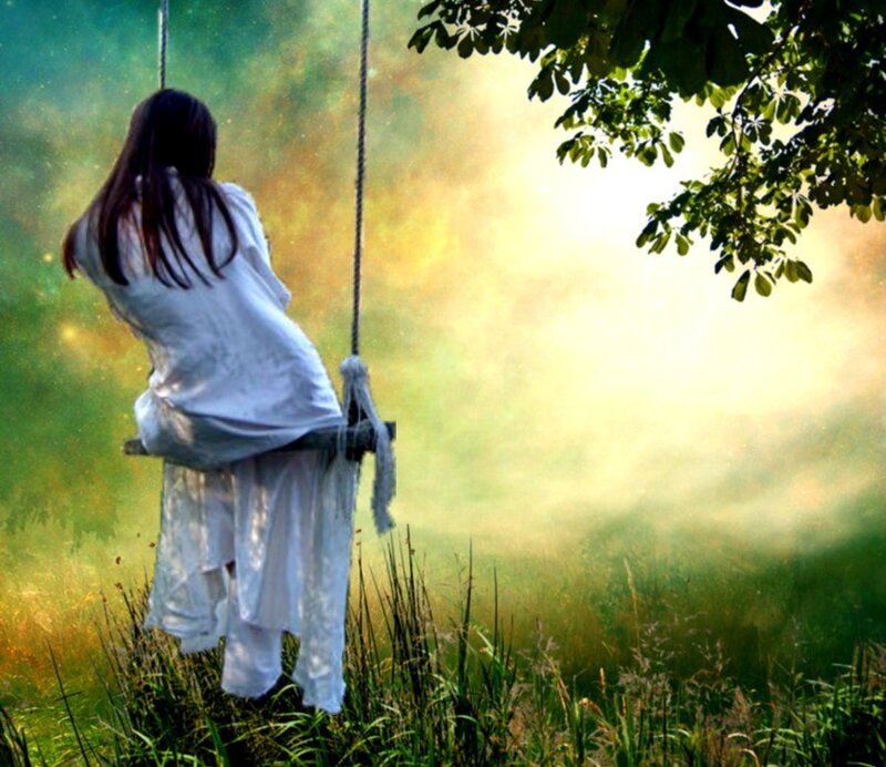 Woman on a swing in a misty field