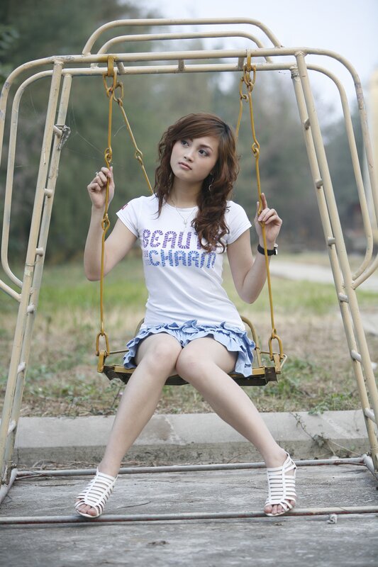 Woman on a swing in park