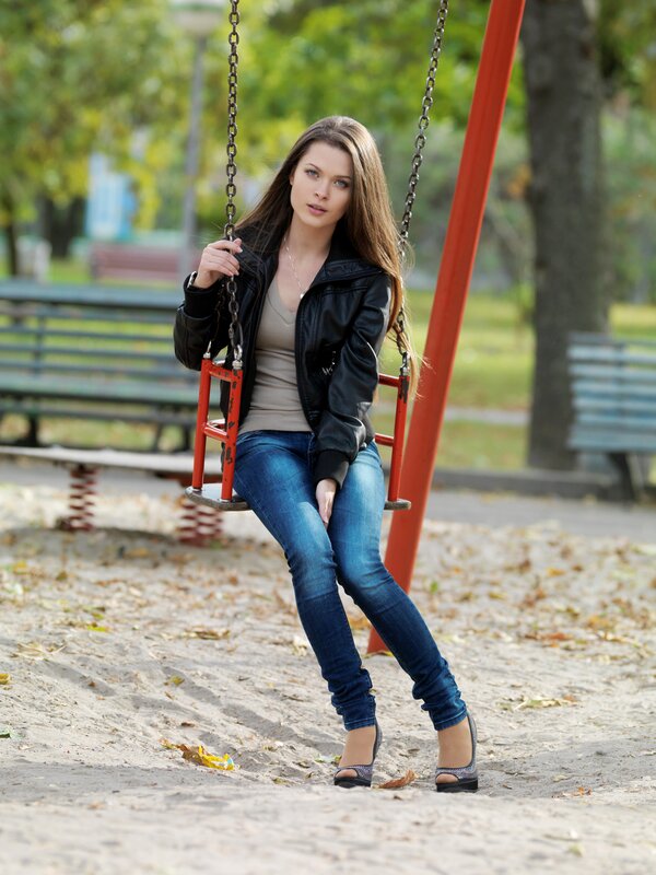 Woman on a swing in the park
