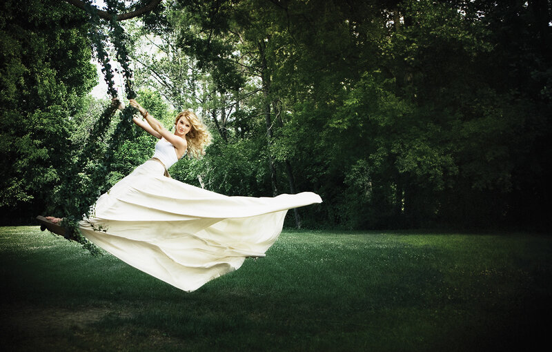 Woman on a swing in the woods