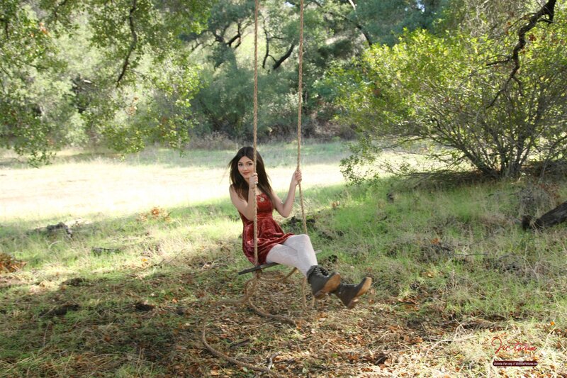 Woman on a swing in the woods