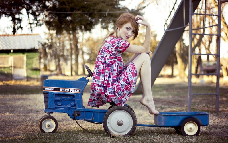 Woman on a toy tractor