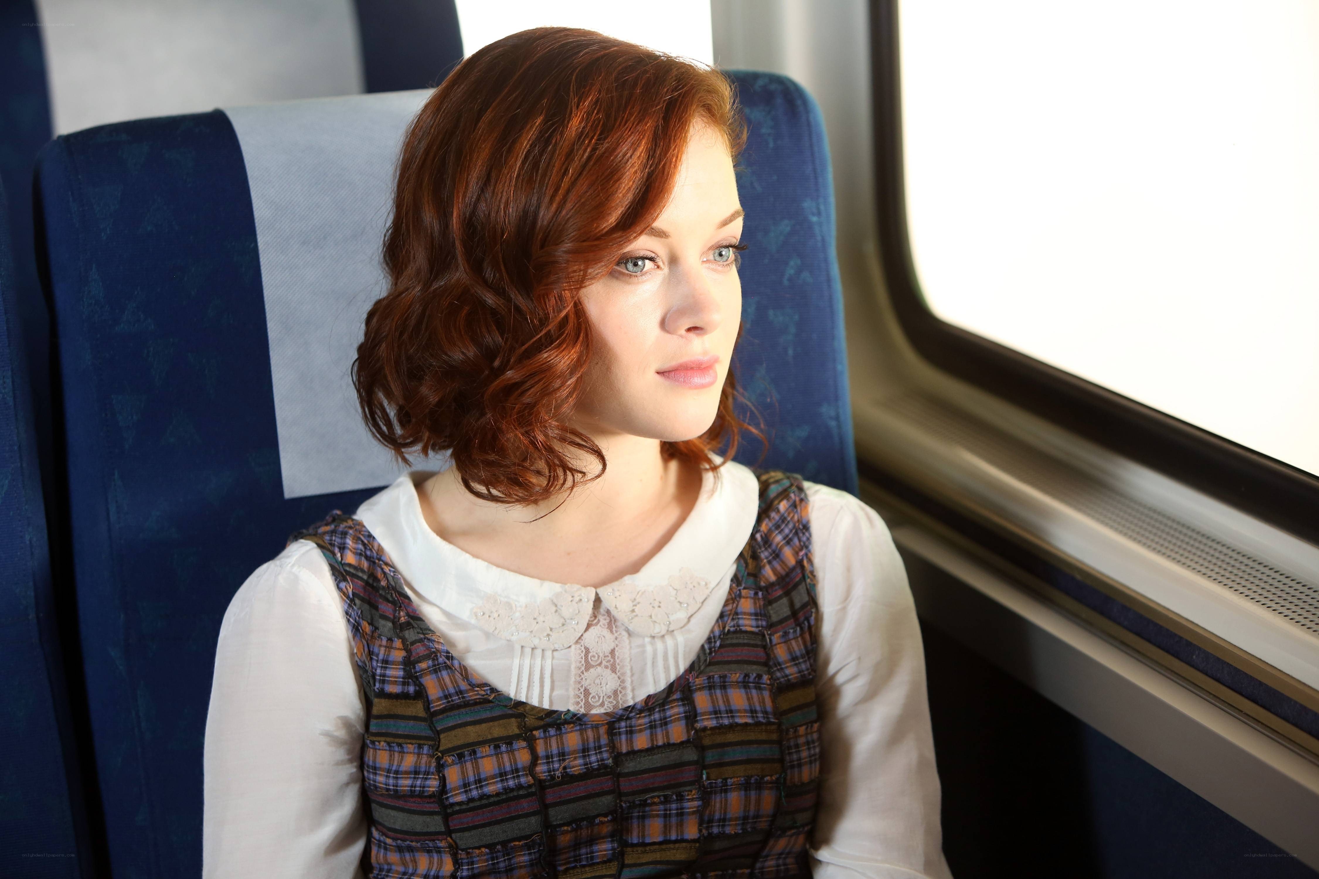 Woman on a train looking out window