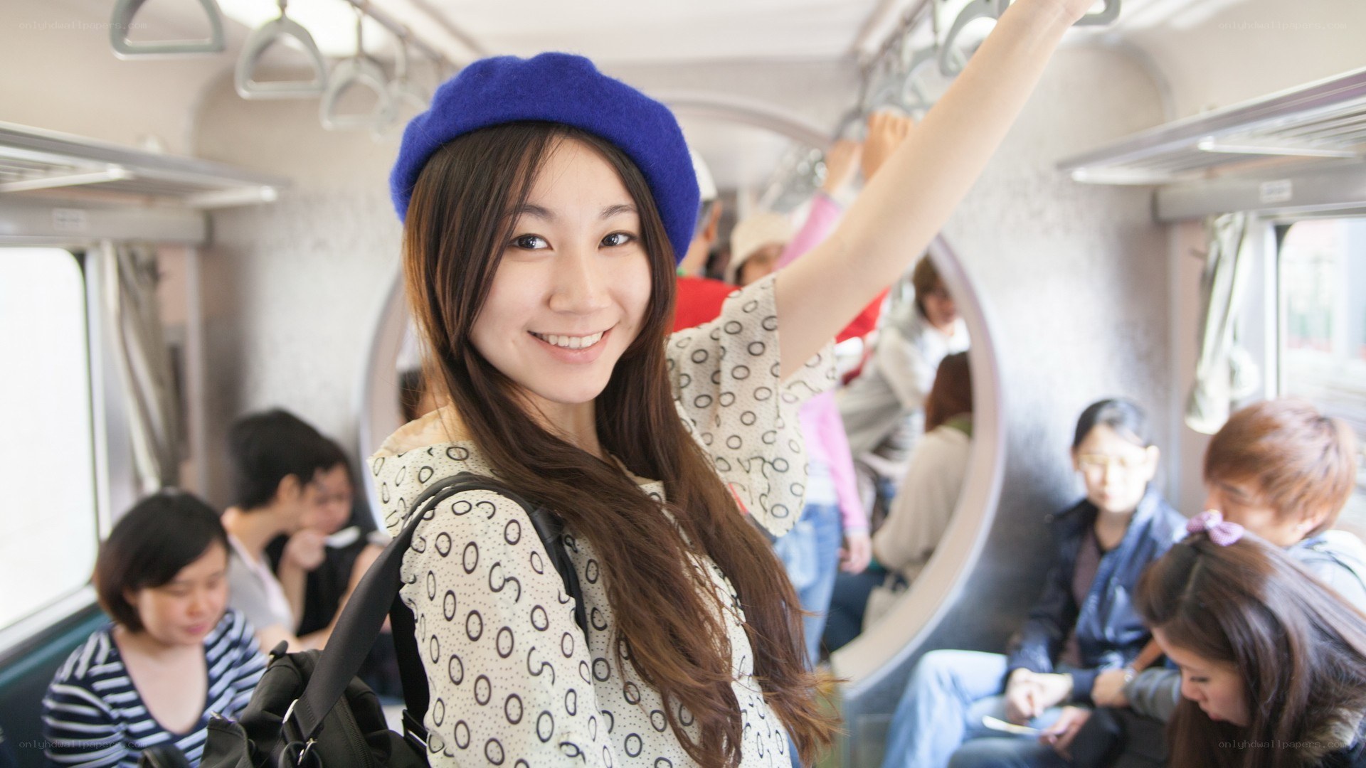 Woman on a train smiling