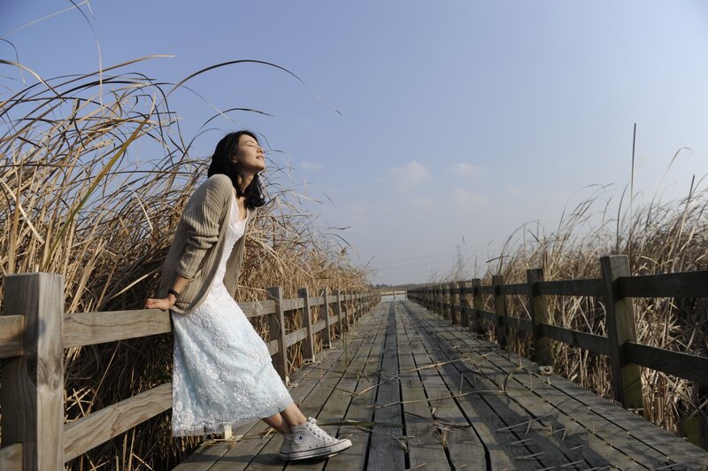 Woman on a wooden bridge