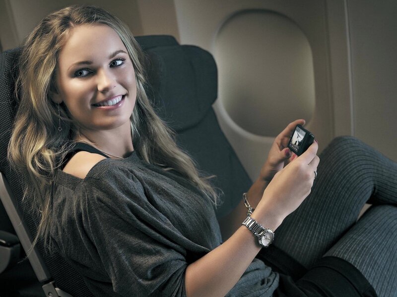 Woman on airplane with phone