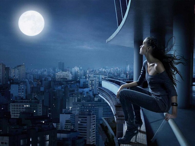 woman on balcony at night