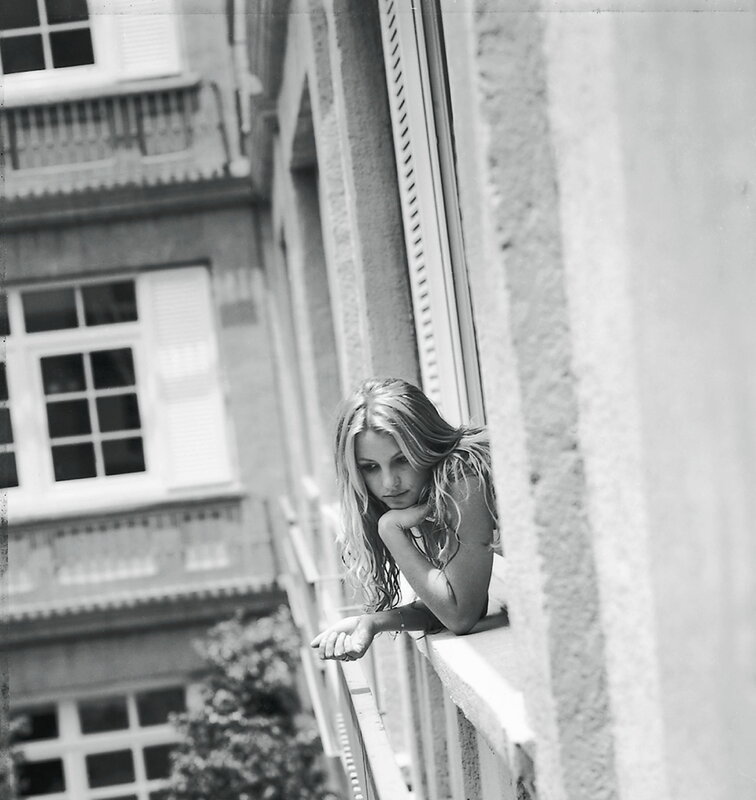 woman on balcony in black and white