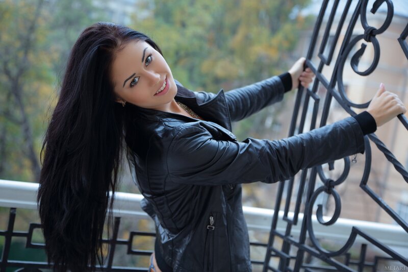 woman on balcony in leather jacket