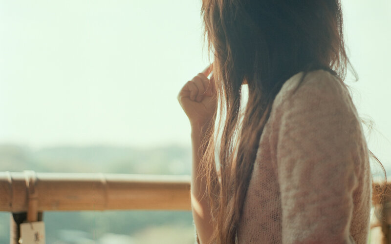 woman on balcony looking out