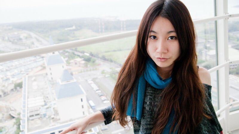 woman on balcony overlooking city