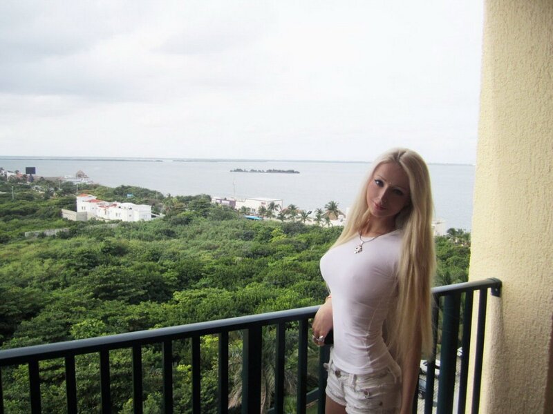 Woman on balcony overlooking coast