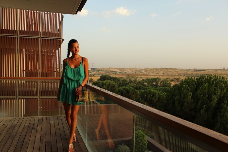 Woman on balcony overlooking landscape