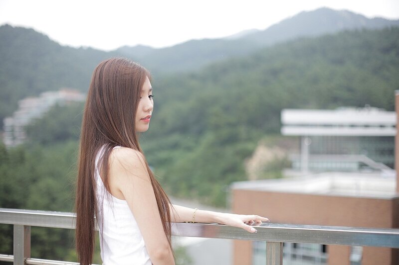 woman on balcony overlooking mountains