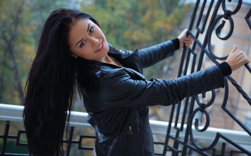 woman on balcony smiling