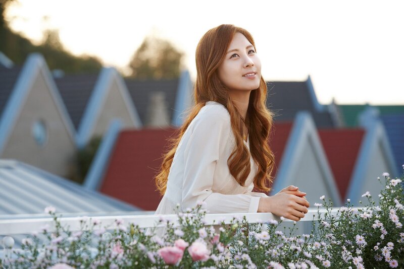 woman on balcony with flowers