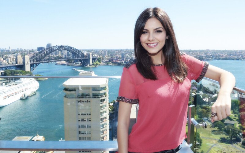Woman on balcony with Sydney Harbour