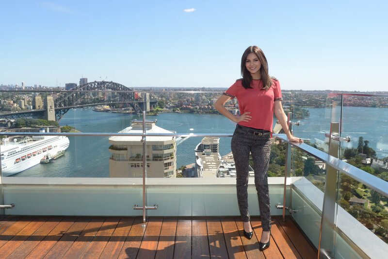 Woman on balcony with Sydney Harbour view