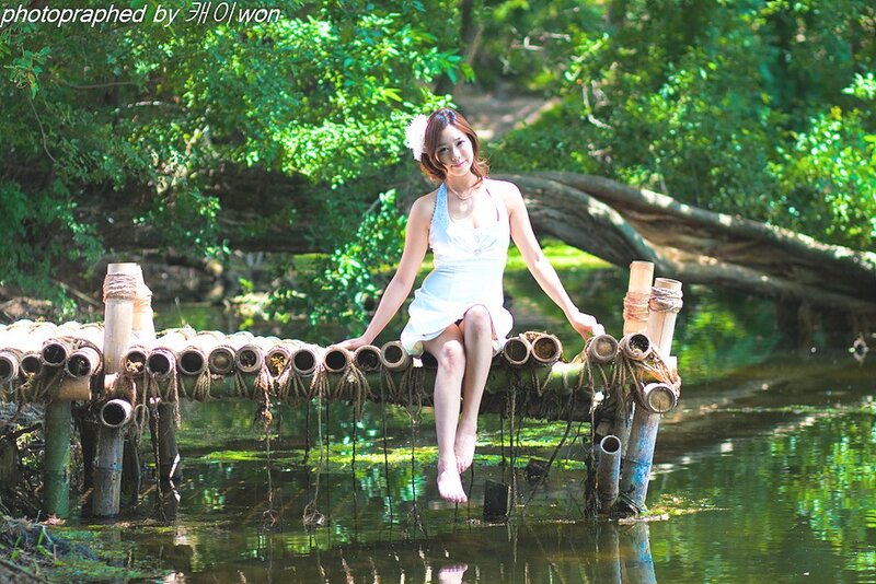 Woman on bamboo bridge in forest