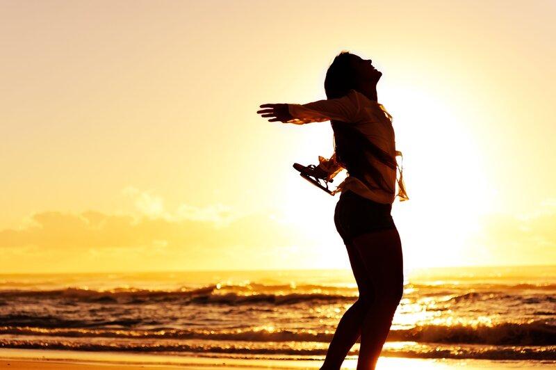 woman on beach at sunset