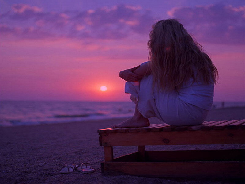 Woman on beach at sunset