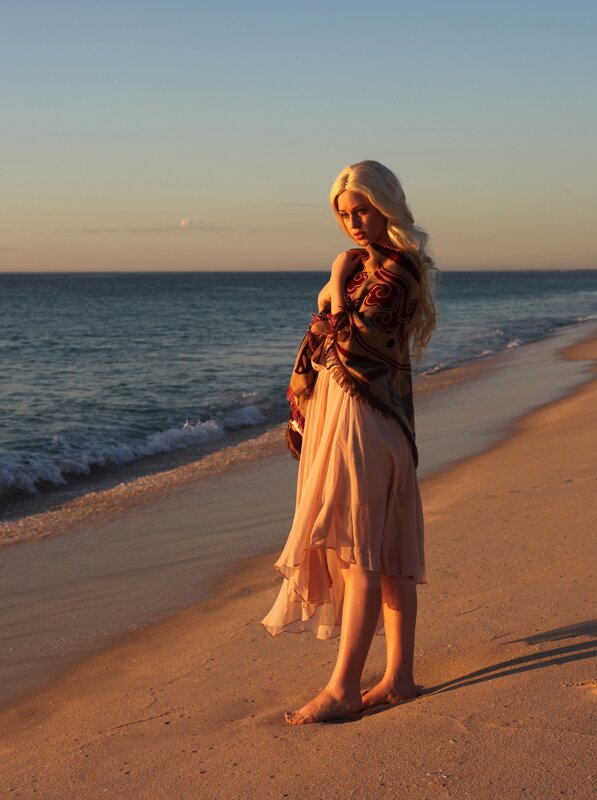 Woman on beach at sunset