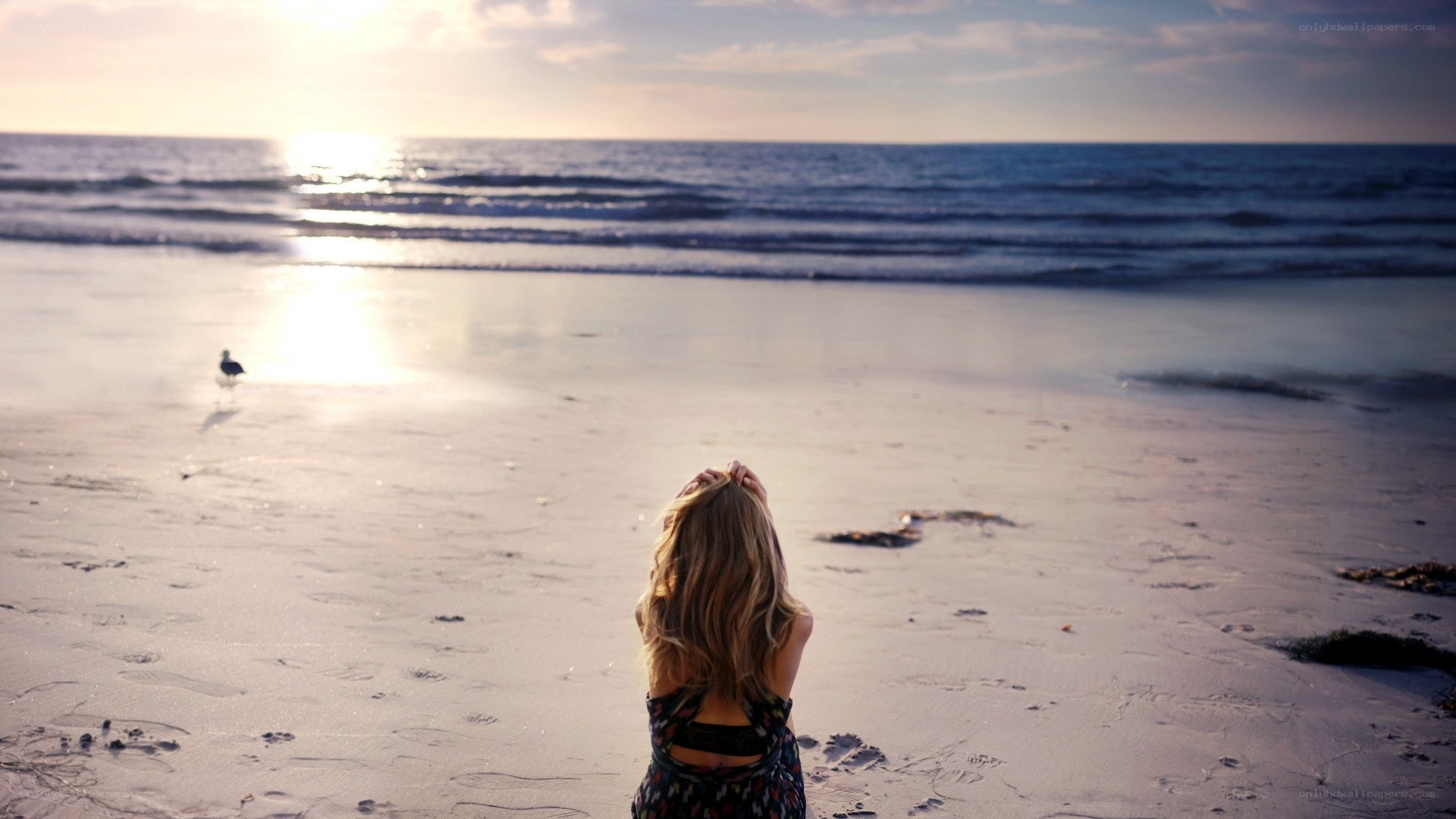 Woman on beach at sunset