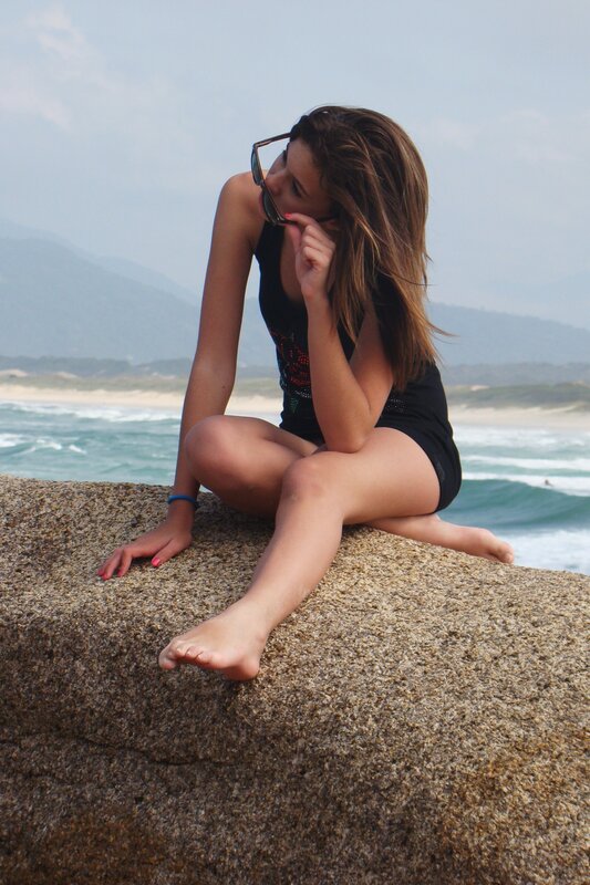 Woman on beach rock