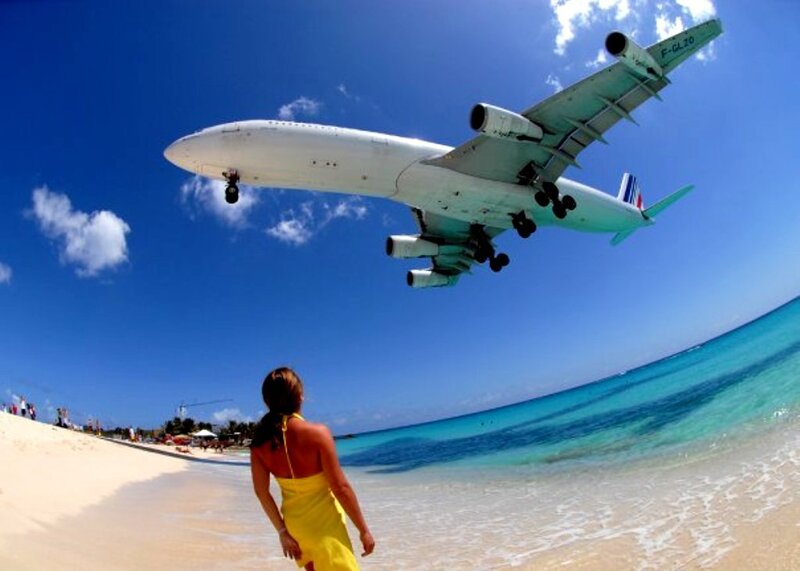 Woman on Beach Watching Plane