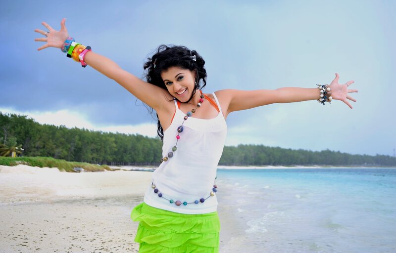 woman on beach with arms outstretched