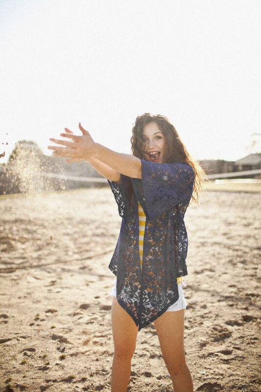 woman on beach with arms outstretched