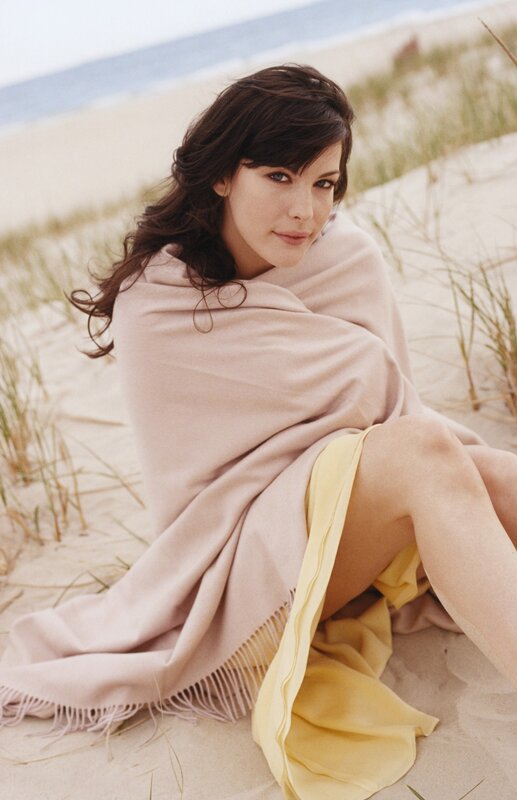 Woman on beach with blanket