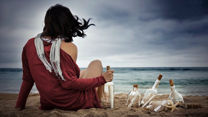 woman on beach with bottles