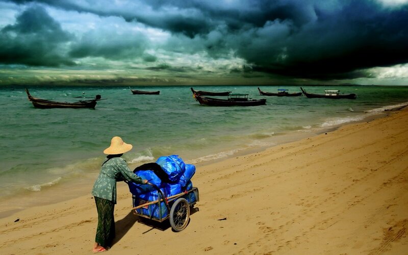 Woman on beach with cart
