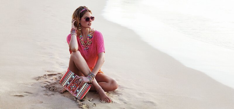 Woman on beach with colorful accessories