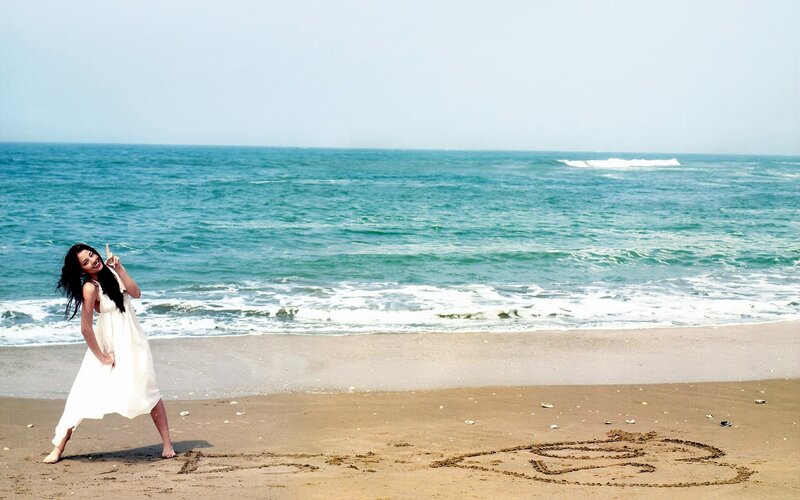 Woman on beach with drawing