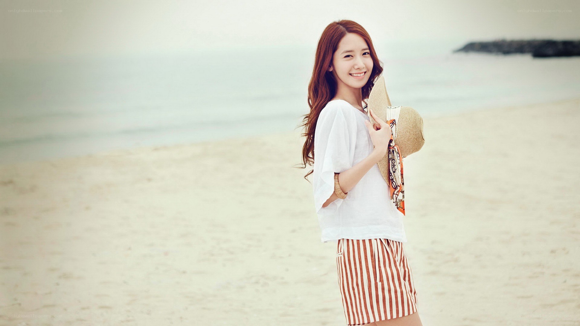 woman on beach with hat