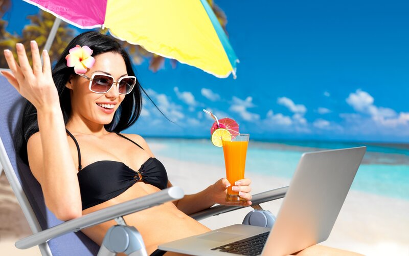 Woman on beach with laptop