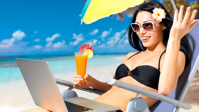 Woman on beach with laptop