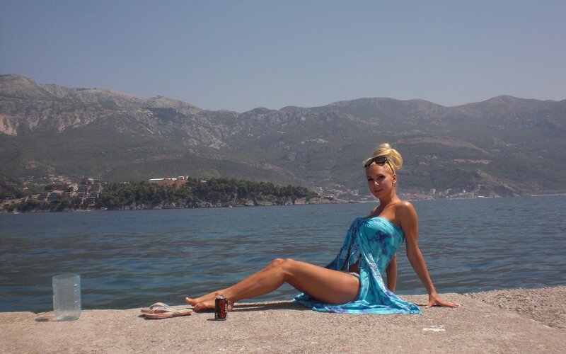 Woman on beach with mountains