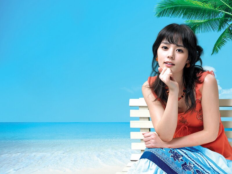 woman on beach with palm tree