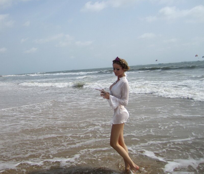 woman on beach with phone