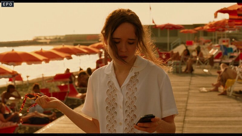 Woman on beach with phone