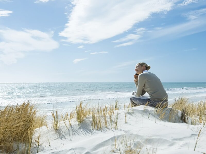 Woman on beach with phone