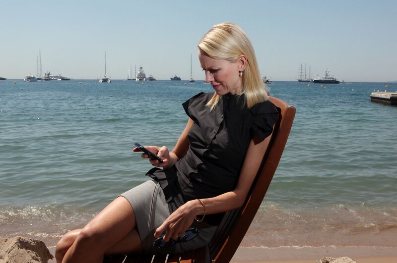 Woman on beach with phone