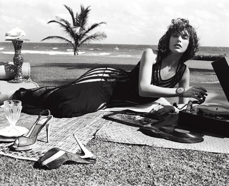 Woman on beach with record player